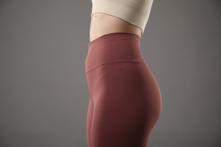 Woman in sportswear on gray background, closeupの写真素材