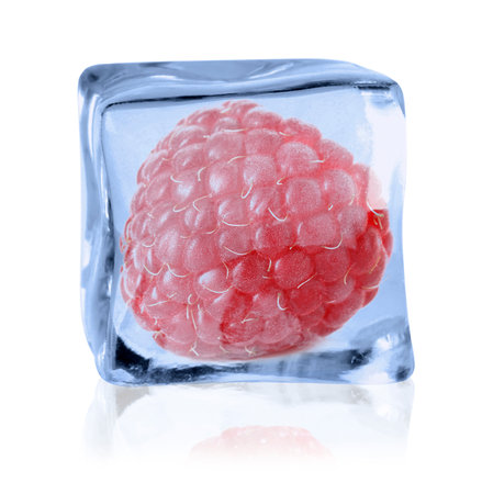 Ripe raspberry in ice cube on white backgroundの写真素材