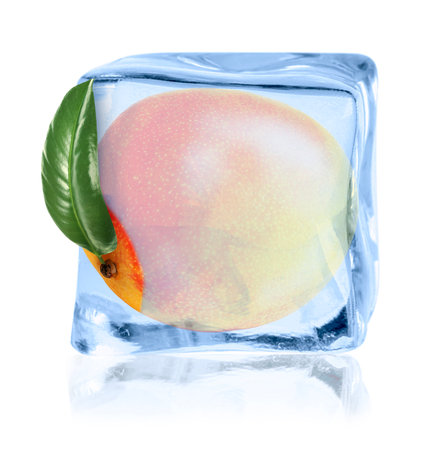 Ripe mango fruit in ice cube isolated on whiteの写真素材