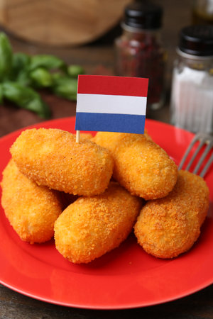 Delicious fried croquettes and flag of Netherlands on table, closeupの写真素材