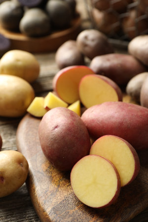 Different types of potatoes on wooden table, closeupの写真素材