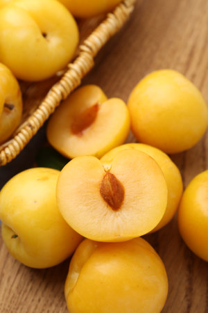 Ripe yellow cherry plums on wooden board, closeupの写真素材