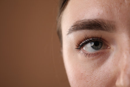 Woman before cosmetic procedure on brown background, closeup. Space for textの写真素材