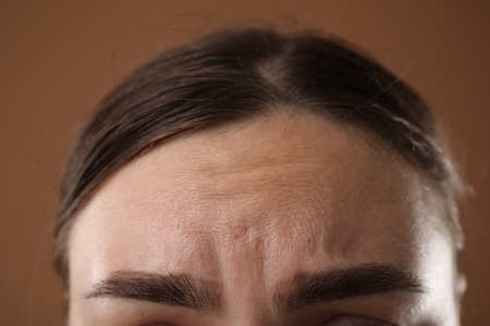 Woman before rejuvenation on brown background, closeupの写真素材