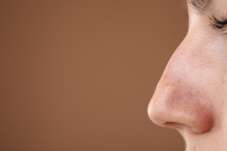 Woman before cosmetic procedure on brown background, closeup. Space for textの写真素材