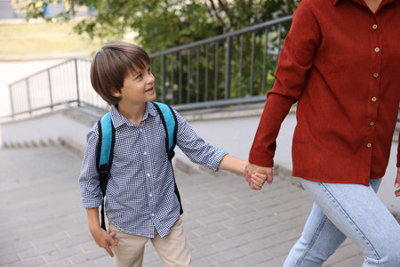 Mother taking her son to school outdoors, closeupの写真素材