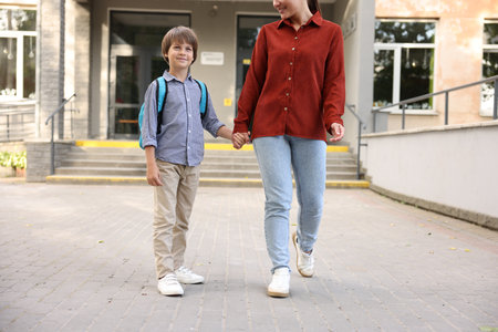 Mother taking her son to school outdoors, closeupの写真素材