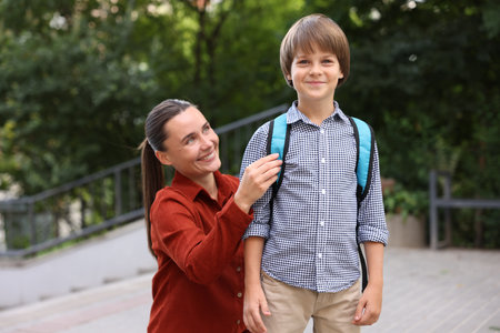 Mother taking her son to school outdoorsの写真素材