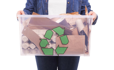 Recycling. Woman holding plastic box with different waste paper on white background, closeupの写真素材