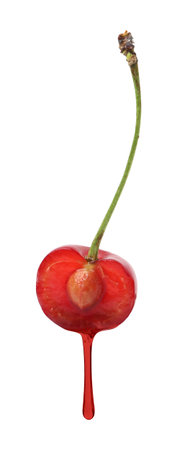 Cherry juice dripping from fruit against white backgroundの写真素材