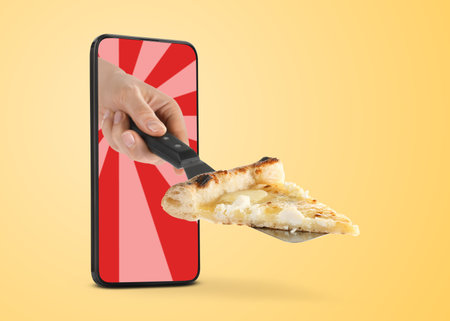 Food ordering and delivery service. Woman's hand giving slice of tasty pizza through mobile phone display, closeup. Orange gradient backgroundの写真素材
