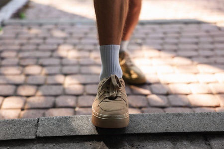 Young man with stylish shoes before running outdoors, closeupの写真素材