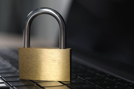 Cyber safety. Metal padlock on laptop, closeupの写真素材