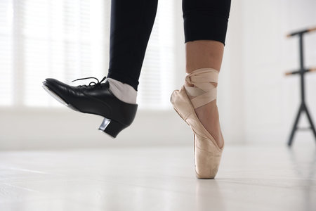 Teenage girl in tap and pointe shoe indoors, closeup