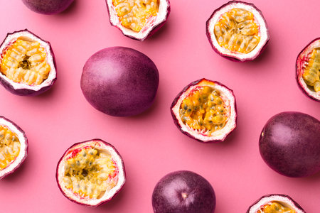 Fresh passion fruits on pink background, flat layの写真素材