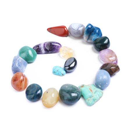 Many different healing stones isolated on white