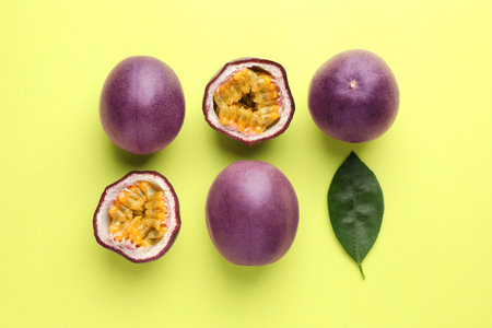 Fresh passion fruits and leaf on pale green background, flat layの写真素材