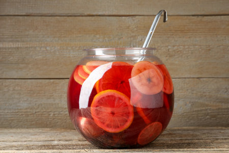 Tasty fruity punch on wooden table. Refreshing drinkの写真素材