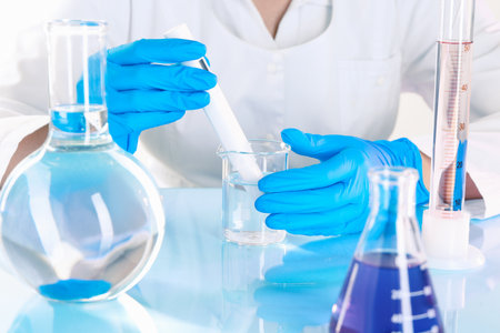 Scientist examining water with nitrate tester at white table in laboratory, closeupの写真素材