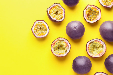 Fresh passion fruits on yellow background, flat lay. Space for textの写真素材