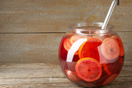 Tasty fruity punch on wooden table, space for text. Refreshing drinkの写真素材