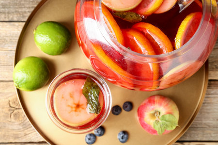 Tasty punch and fruits on wooden table, top view. Refreshing drink