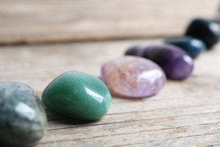 Many different healing stones on wooden table, closeupの写真素材