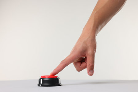 Man pressing red button on white background, closeupの写真素材