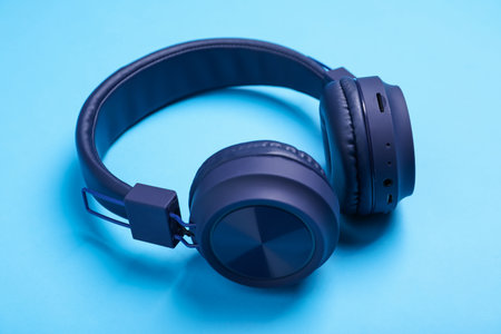 Pair of stylish headphones on light blue background, closeupの写真素材