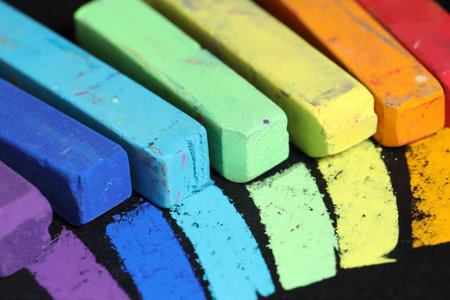 Colorful chalk pastels on black background, closeupの写真素材
