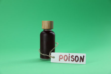 Bottle with poison on green background, closeupの写真素材