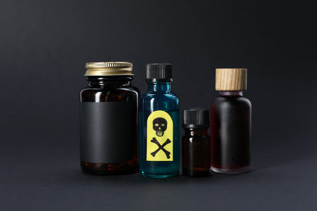 Bottles of poisons with warning sign on black backgroundの写真素材