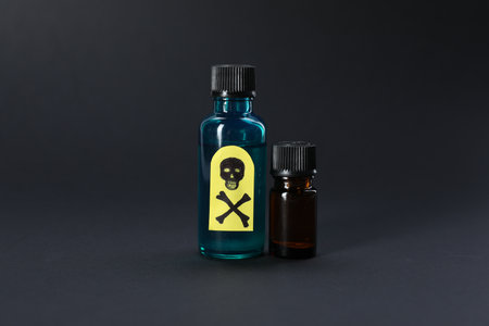 Bottles of poisons with warning sign on black backgroundの写真素材