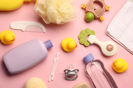 Baby bath accessories, care products and toys on pink background, flat layの写真素材