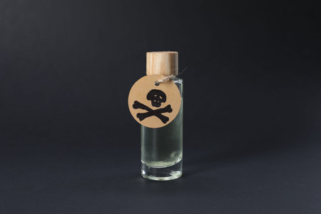 One bottle of poison with warning sign on black background