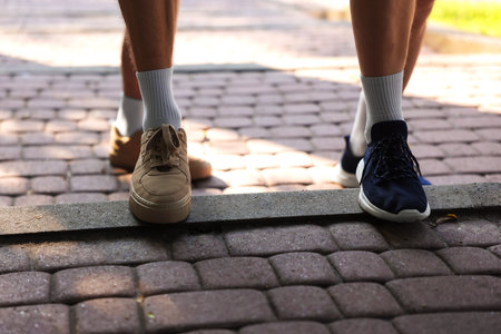 Young man running with professional personal trainer outdoors, closeupの写真素材