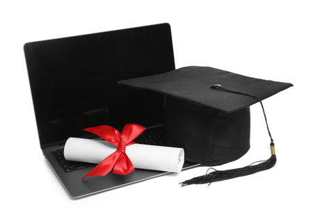 Graduation cap, laptop and diploma isolated on whiteの写真素材