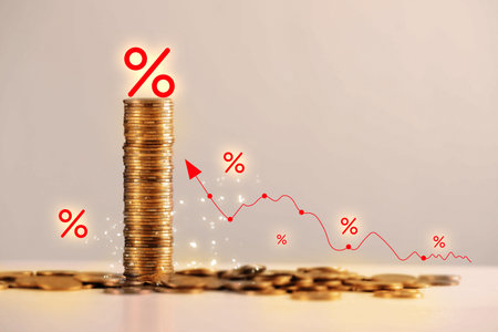 Percent signs, arrow and stacked coins against dark beige backgroundの写真素材
