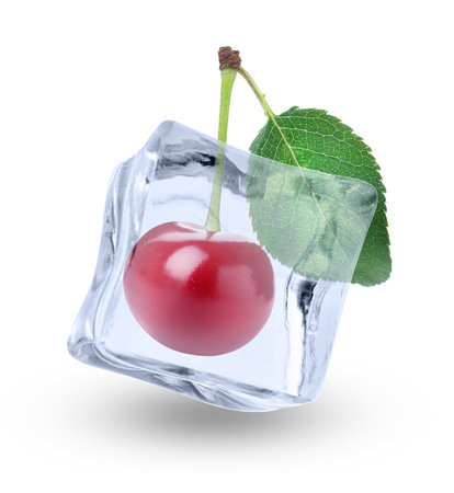 Fresh cherry in clear ice cube isolated on whiteの写真素材