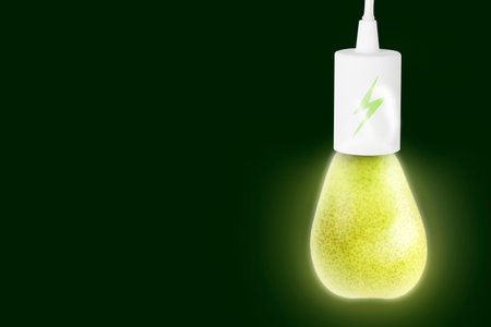 Electricity and nature. Pear as glowing light bulb with lightning symbol against dark green background. Space for textの写真素材
