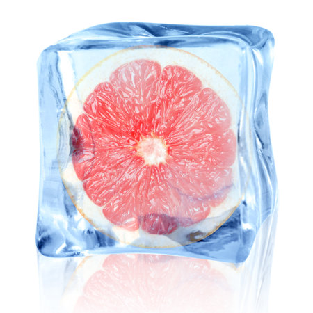 Half of fresh grapefruit inside ice cube on white backgroundの写真素材