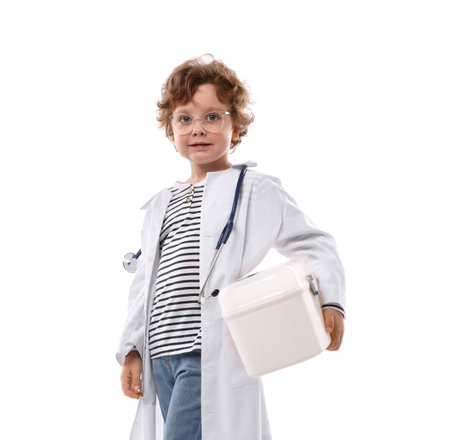 Choice of profession. Little boy with stethoscope and first aid kit pretending to be a doctor on white backgroundの写真素材