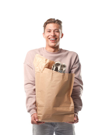 Recycling. Smiling man with bag full of different paper waste on white backgroundの写真素材