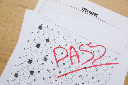 Answer sheet with word Pass on wooden table, top view. Student passing examの写真素材