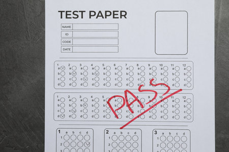 Answer sheet with word Pass on gray textured table, top view. Student passing examの写真素材