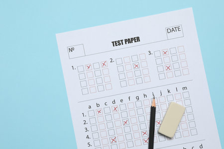 Answer sheet, pencil and eraser on light blue background, flat lay. Student passing examの写真素材