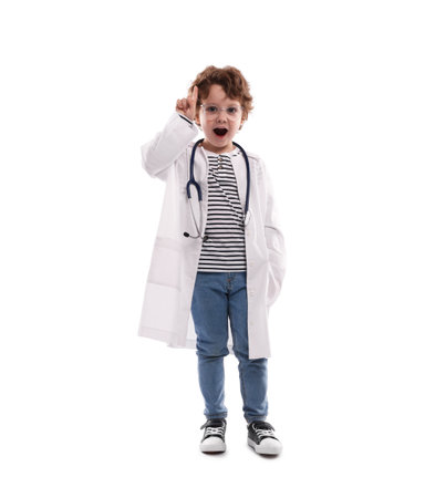 Choice of profession. Little boy with stethoscope pretending to be a doctor on white backgroundの写真素材