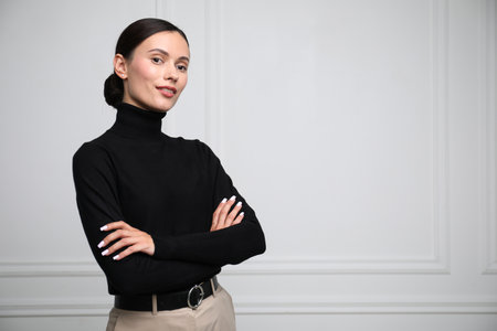 Portrait of beautiful woman near white wall. Space for textの写真素材