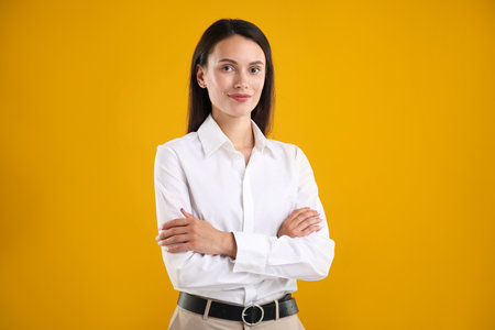 Portrait of confident businesswoman on yellow backgroundの写真素材