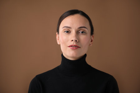 Portrait of beautiful woman on brown backgroundの写真素材